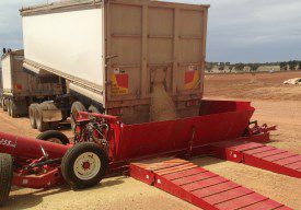 Truck Unloading Grain into Drive Over
